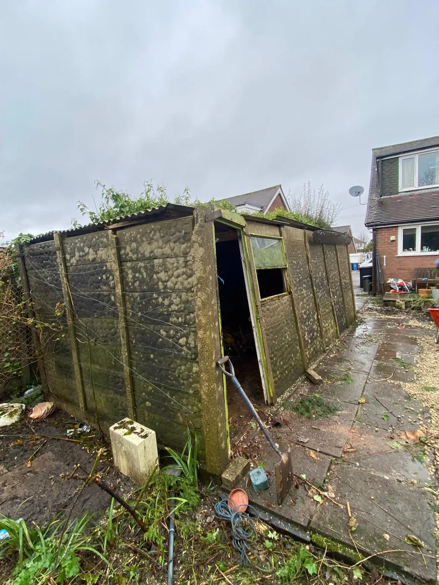 Old deteriorated garden shed before removal